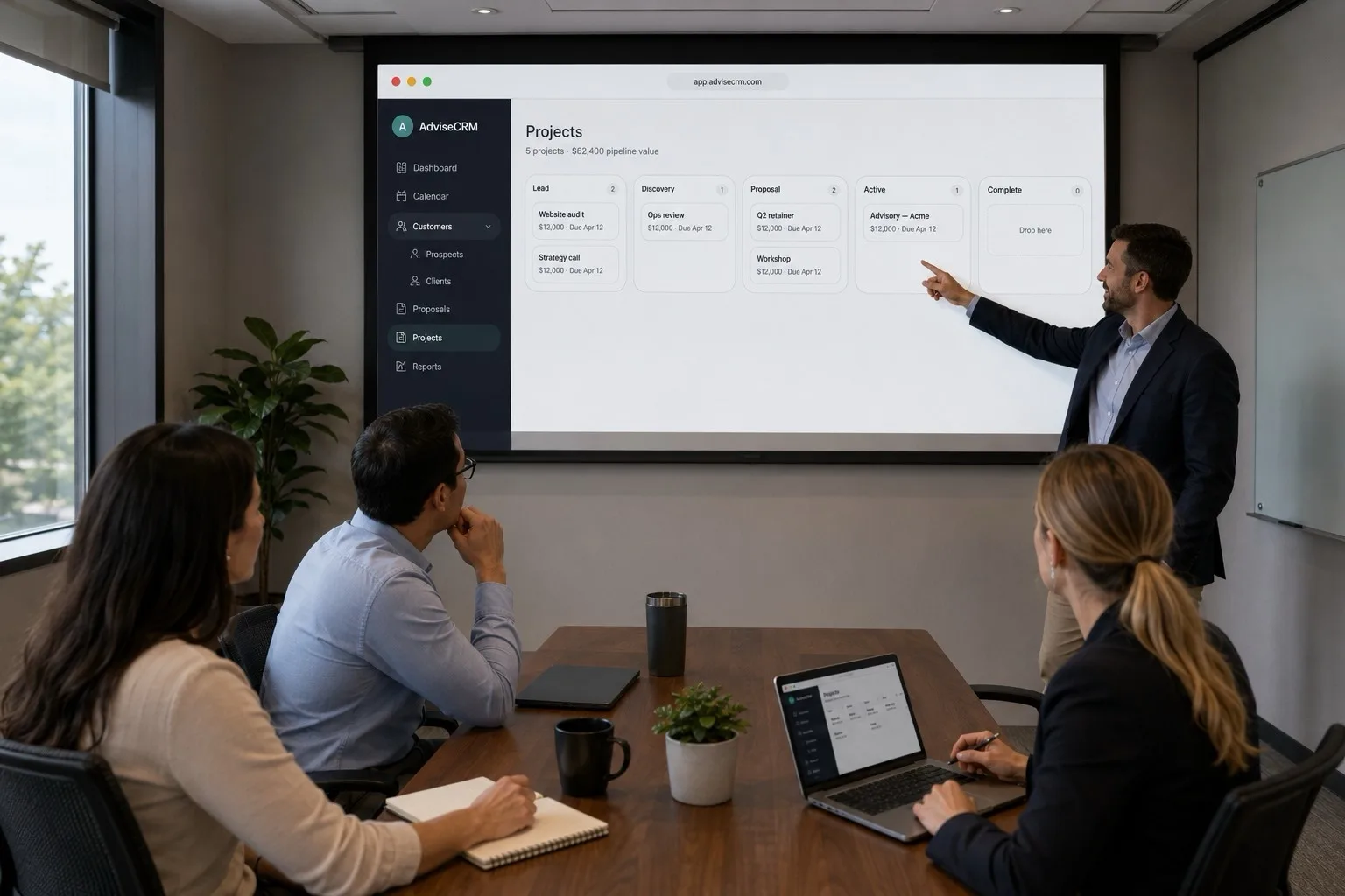 Consulting team reviewing the AdviseCRM projects pipeline on a conference screen